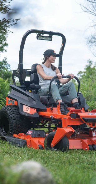 Lady on an Orange Ride On Mower