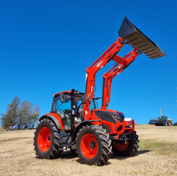 Red Kioti Tractor with loader lifted up
